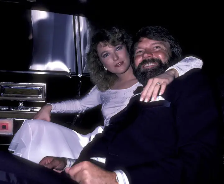 Musician Glen Campbell and Tanya Tucker on their way in the back of a car arm-in-arm to attend Glen Campbell Golf Tournament Dinner Gala on February 17, 1981 at the Century Plaza Hotel in Century City, California.