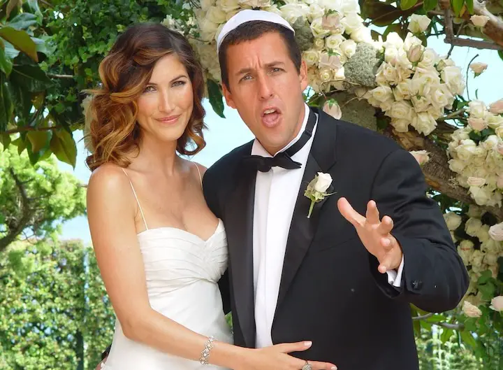 Adam Sandler in an awkward pose alongside his wife during the photoshoot of their wedding.