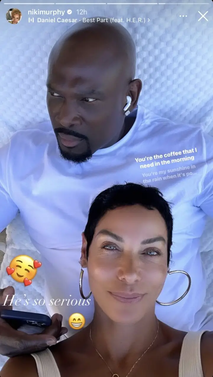 A screenshot of an Instagram Story posted by Nicole Murphy taking a selfie with a man, her rumored boyfriend, behind her with caption, "He's so serious".